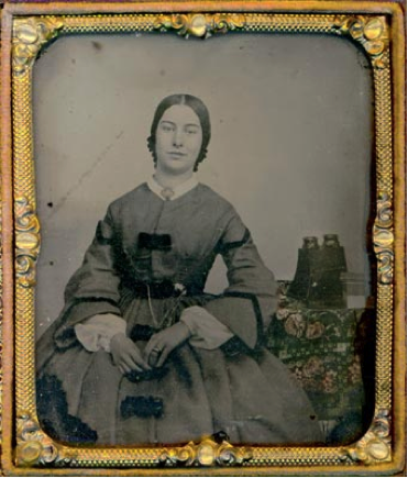 Figure 6: 1850s ambrotype. A Brewster-style lenticular stereoscope rests on the table behind the woman.